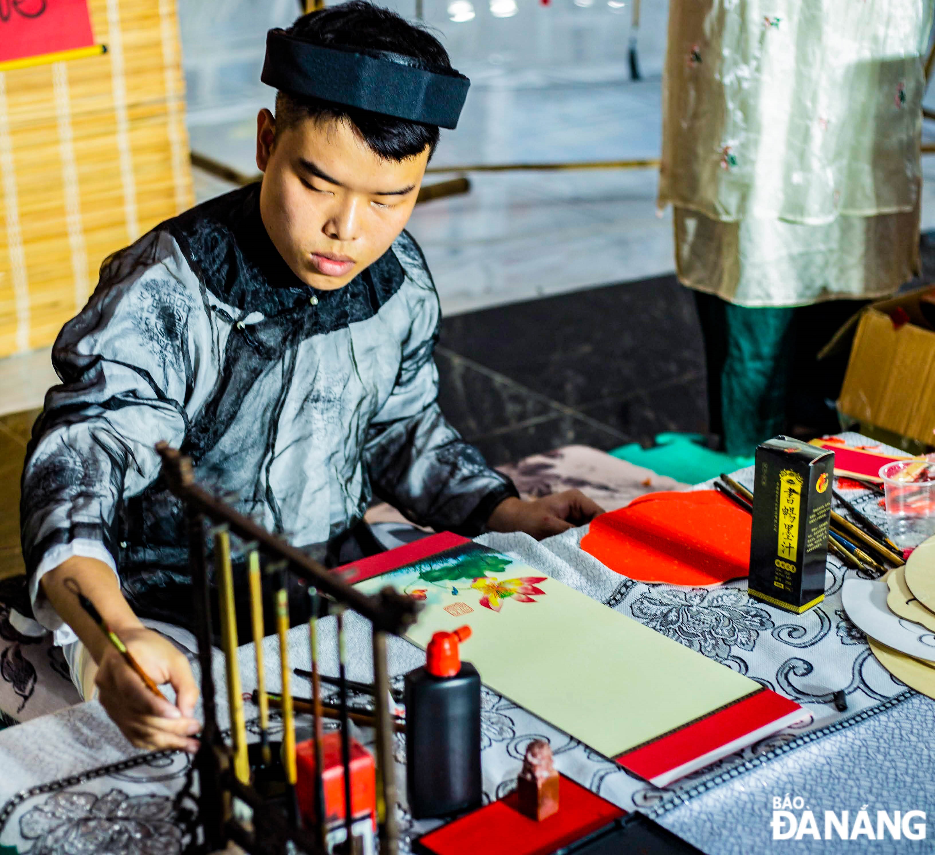 A calligrapher doing calligraphy at the park