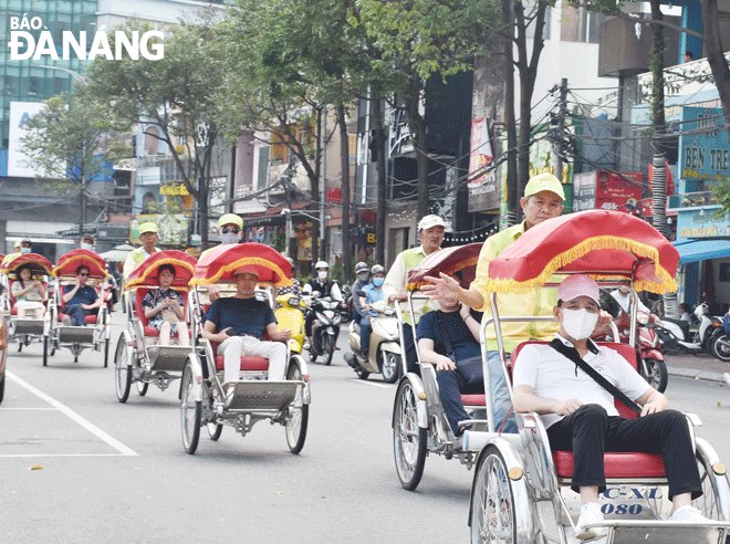 Foreign visitors taking a cyclo tour in Da Nang. Photo: THU HA