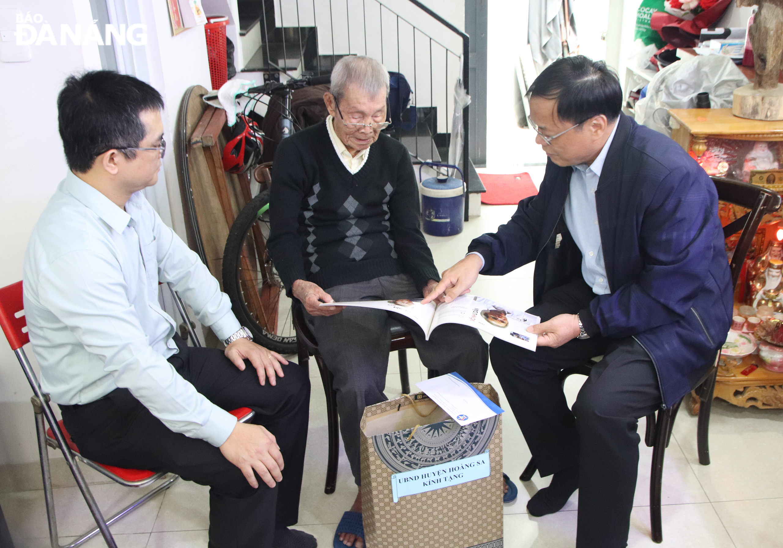 Director of the Department of Home Affairs cum Chairman of Hoang Sa Island District People's Committee Vo Ngoc Dong (right) giving a gift to Mr. Pham So (middle). Photo: TRONG HUY