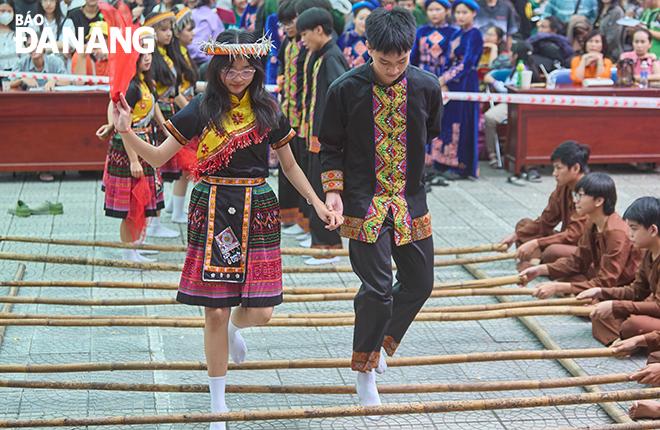 Pupils participating in ‘nhay sap’ (dance with bamboo poles)