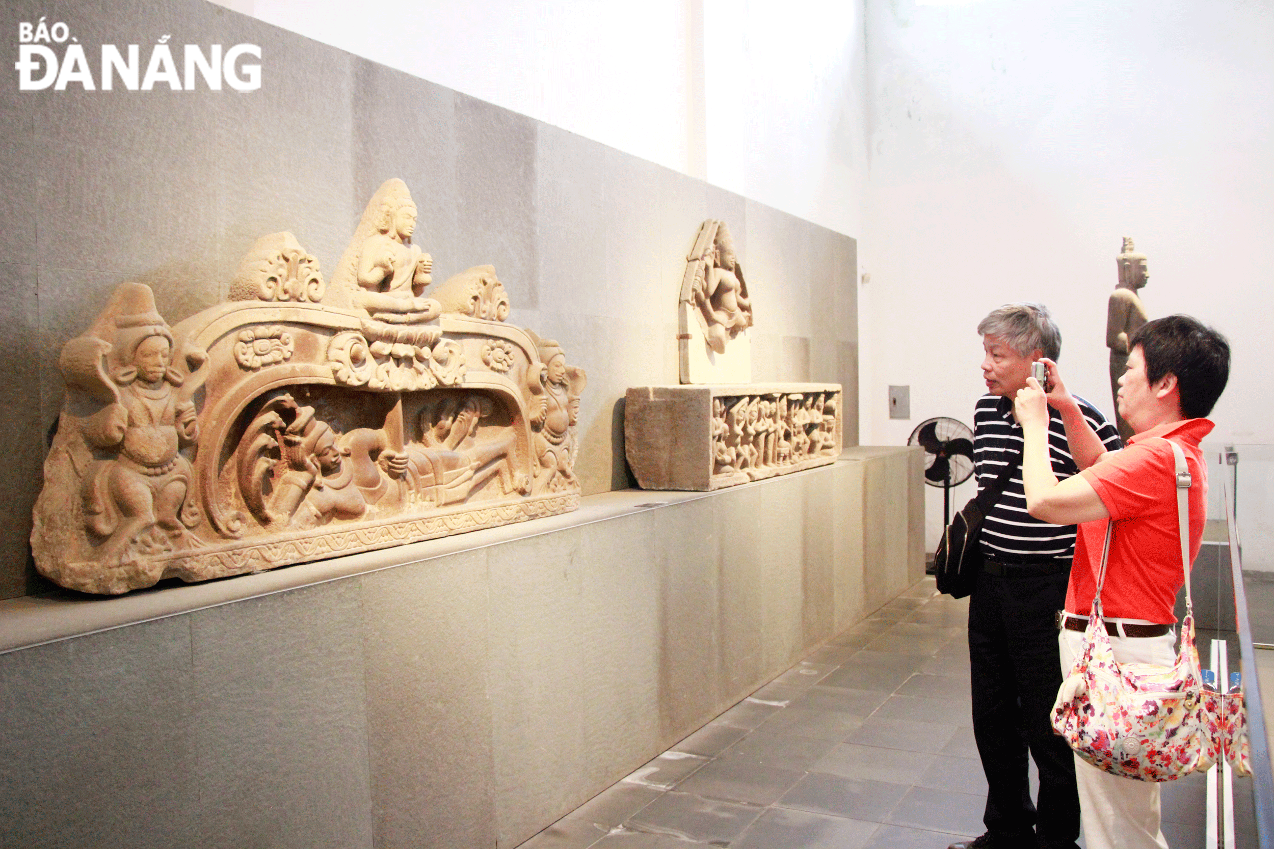 Tourists admire the Brahma My Son E1 Relief, which has been bestowed Viet Nam's national treasure status, at the Da Nang Museum of Cham Sculpture .