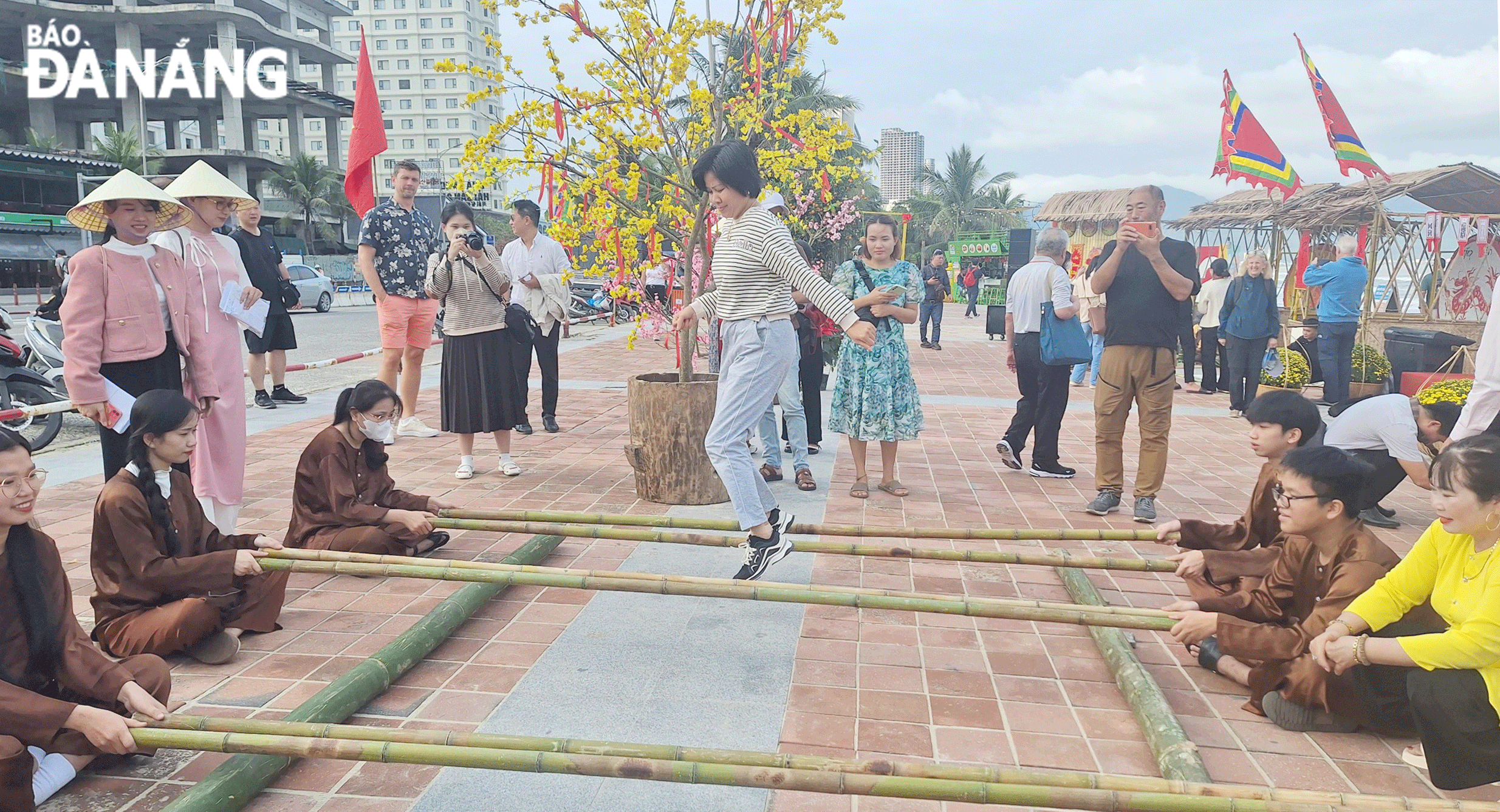 Tourists enjoy 'mua sap' (cheraw dance) at My An beach. Photo: THU HA