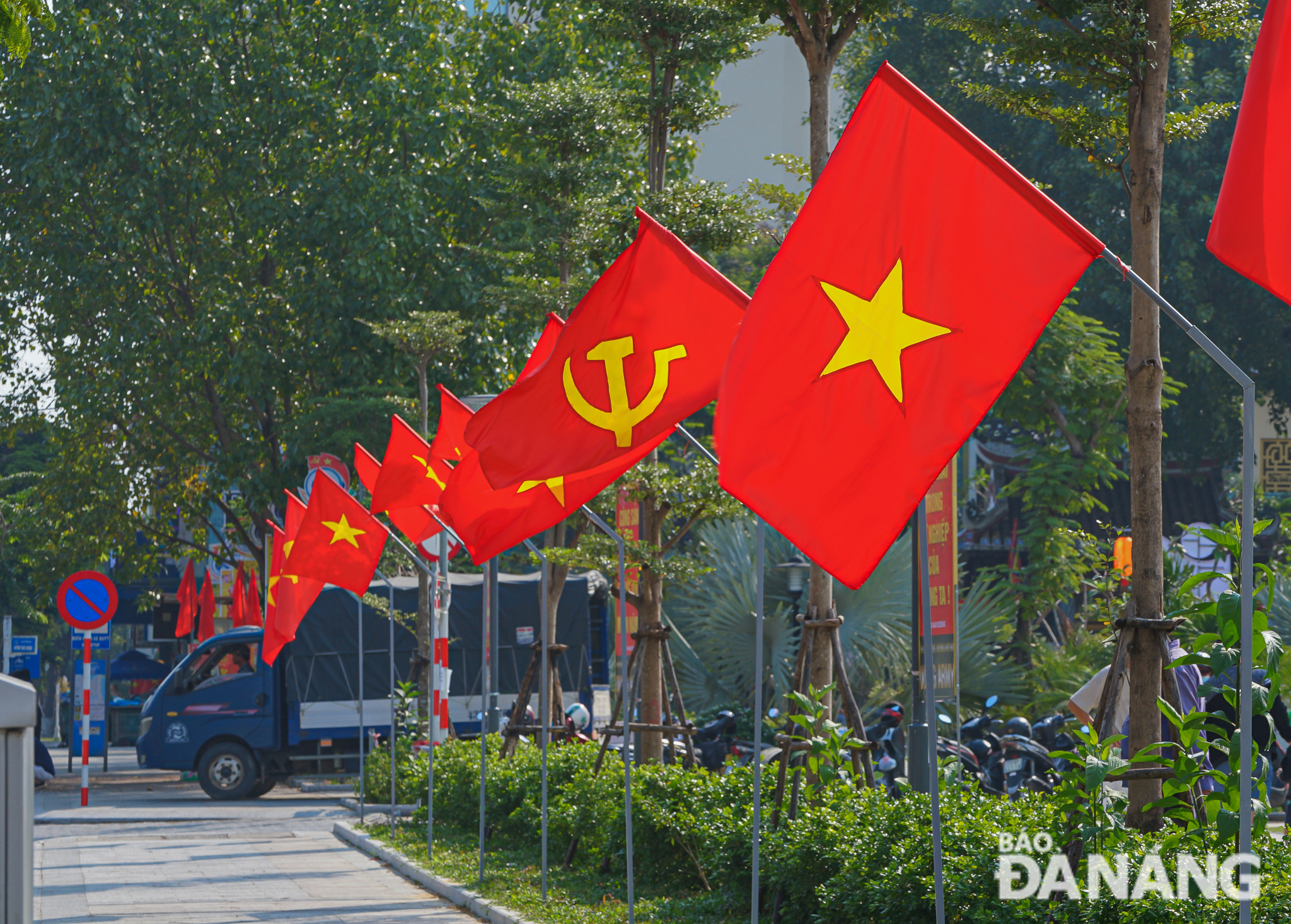 Red flags with yellow stars, and the Party's hammer and sickle flags, fly on every street corner