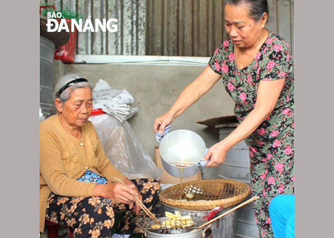 A scene of making dried sesame cakes in Quang Chau village