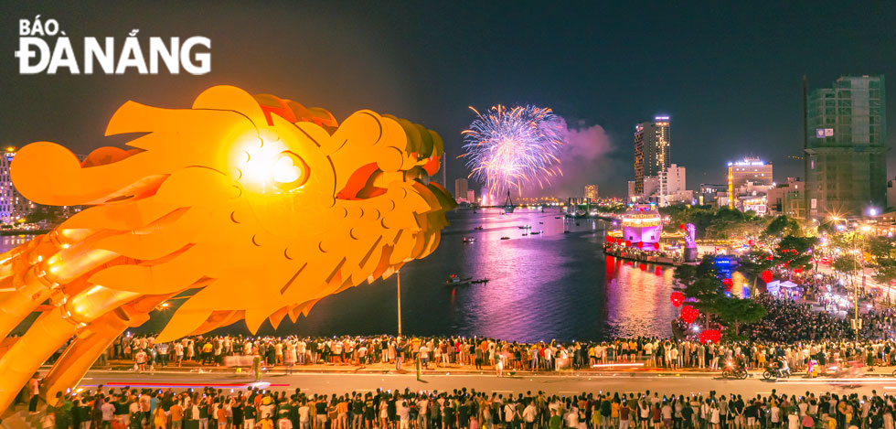 People gather on the Dragon Bridge to enjoy the fireworks display on the Han River