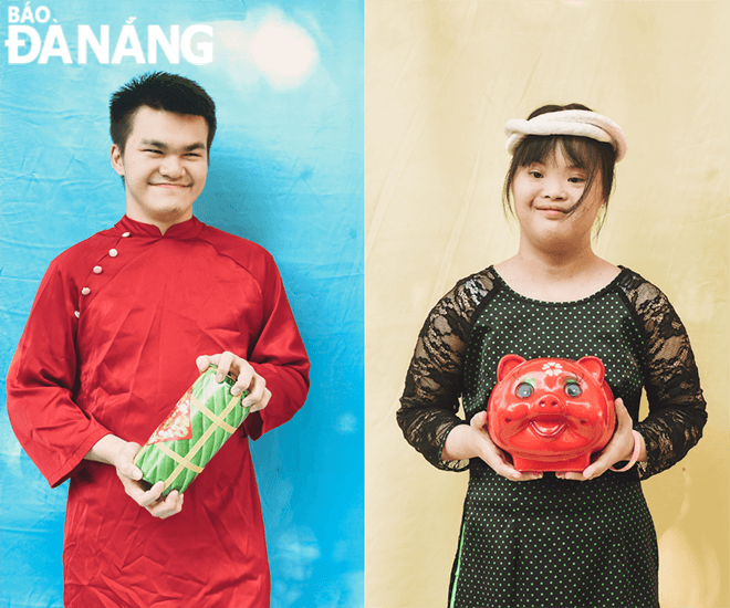 Children at the municipal Red Cross Society's Charity Career Orientation Centre dress up in 'Ao Dai' (Vietnamese traditional dress) to take pictures for Tet for the first time .