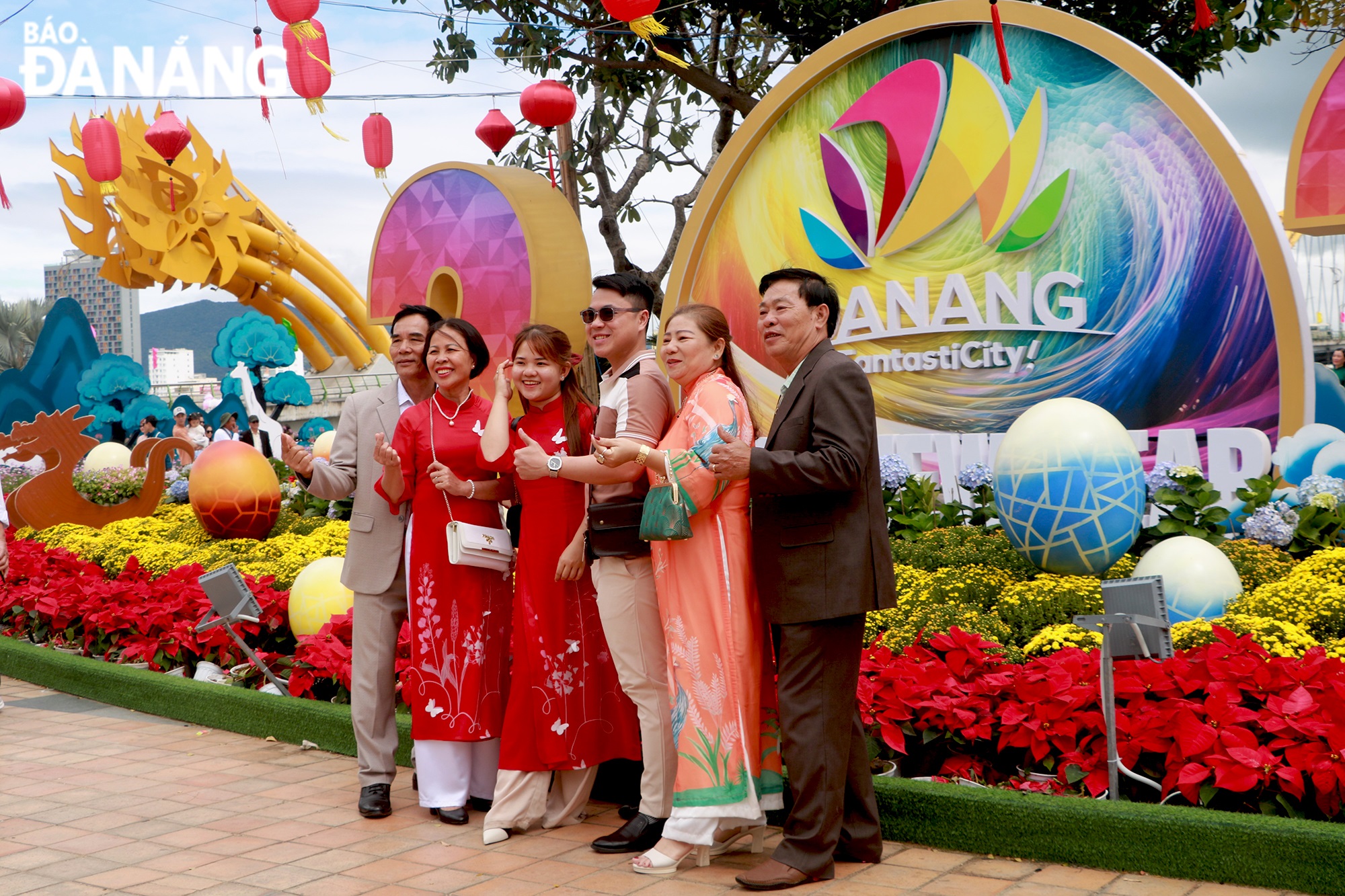 A family is seen posing for a photo at the Bach Dang Flower Street