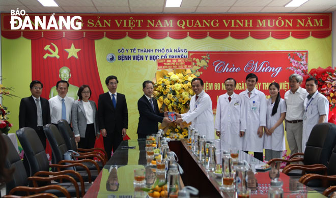 Bí thư Thành ủy Nguyễn Văn Quảng (thứ 5, từ trái sang) chúc mừng tập thể cán bộ, nhân viên Bệnh viện Y học cổ truyền Đà Nẵng. Ảnh: PHAN CHUNG