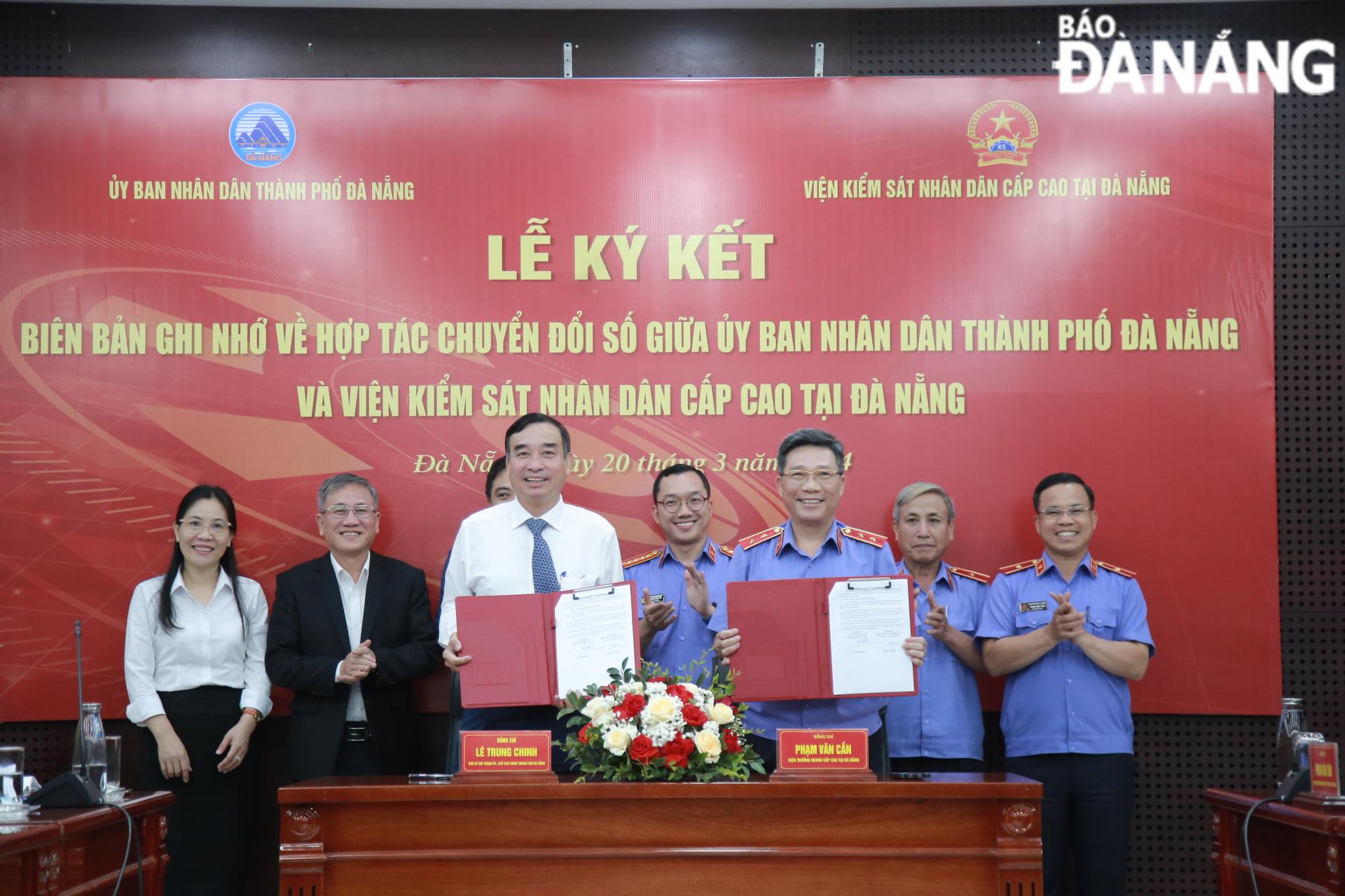 Chairman of the Da Nang People's Committee Le Trung Chinh (3rd, left) and Director of the High-level People's Procuracy in Da Nang Pham Van Can (3rd, right) sign a Memorandum of Understanding on digital transformation. Photo: CHIEN THANG