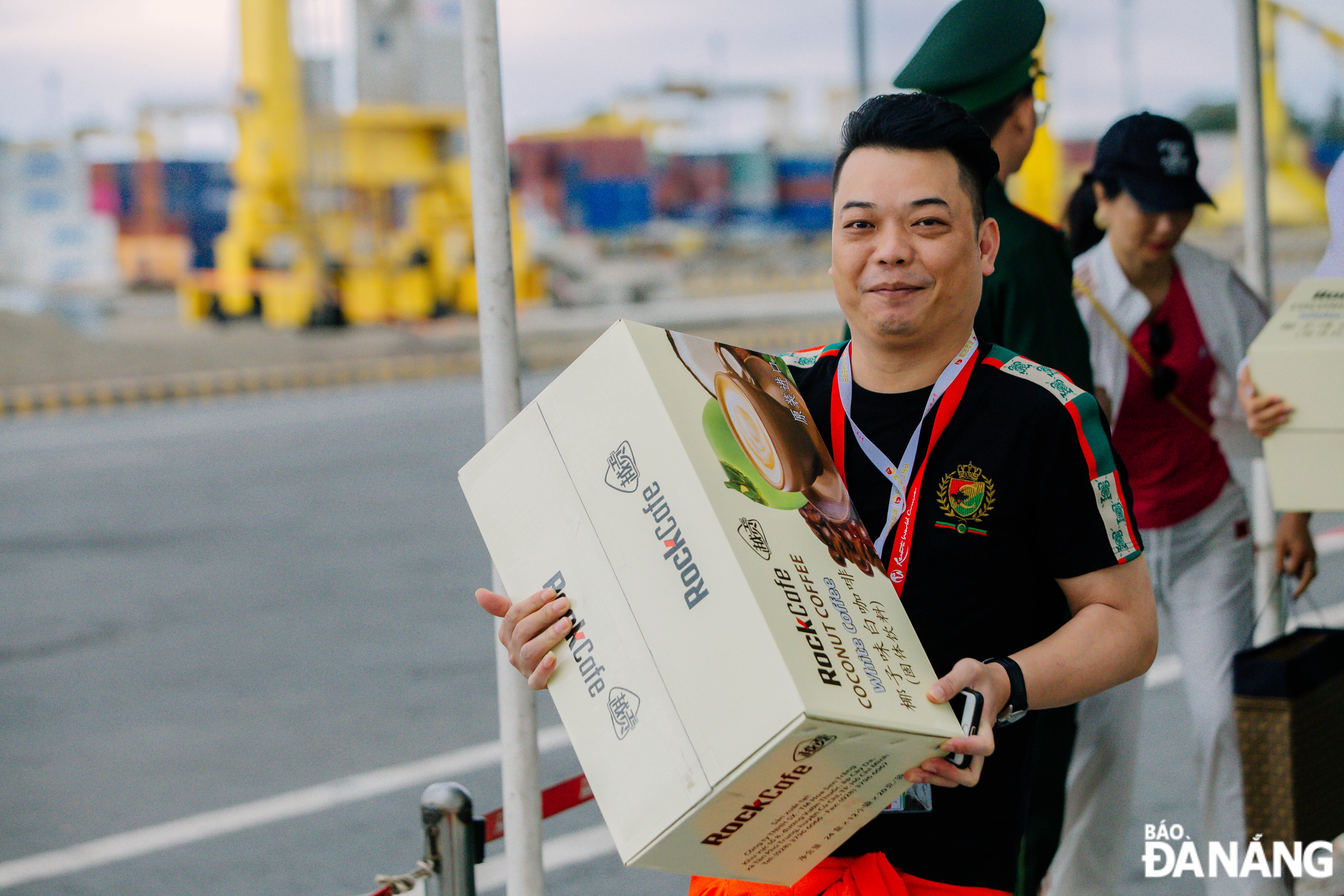 Mr. Zheng Xiaoqing from Jilin Province, China, is holding a box of coffee to bring home as a gift.