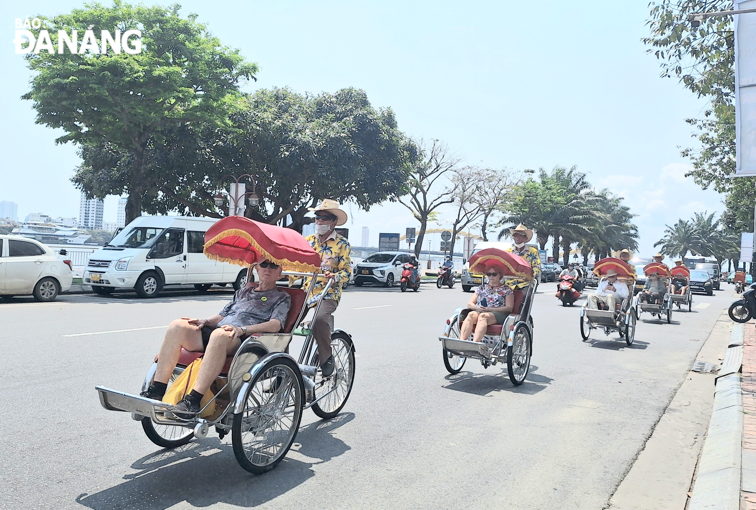 Foreign visitors taking a cyclo tour in Da Nang. Photo: THU HA