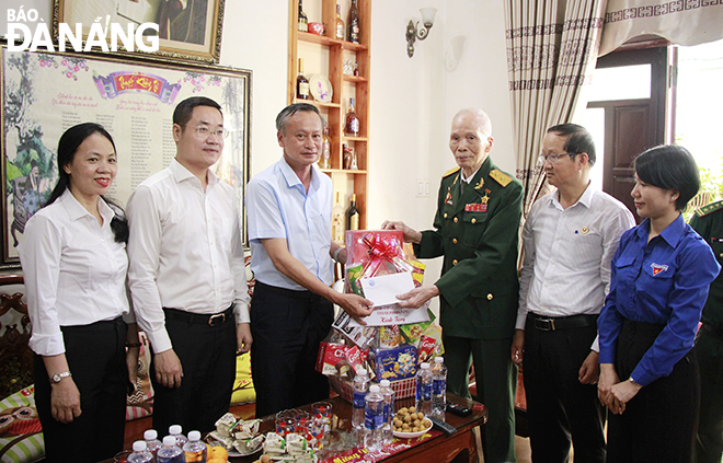 Trưởng ban Tuyên giáo Đoàn Ngọc Hùng Anh (thứ 3, từ trái sang) tặng quà cho ông Nguyễn Hồng Lan (SN 1930, trú quận Hải Châu). Ảnh: X.D