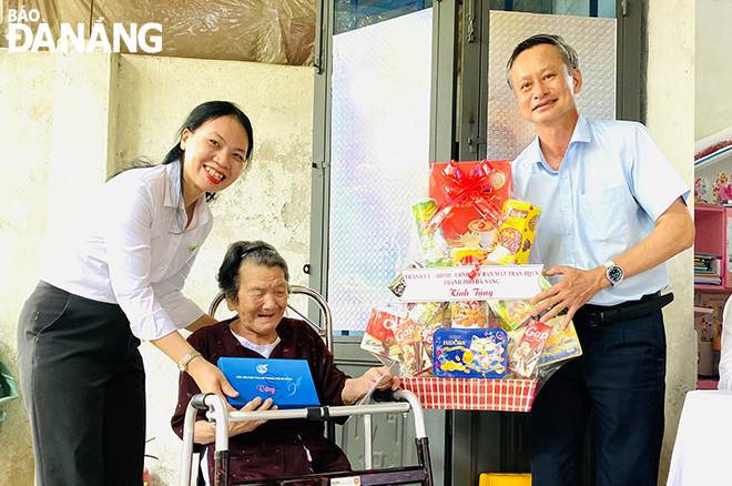 Trưởng ban Tuyên giáo Đoàn Ngọc Hùng Anh (bên phải) tặng quà cho bà Trần Thị Thảo (SN 1933, trú quận Liên Chiểu). Ảnh: X.D