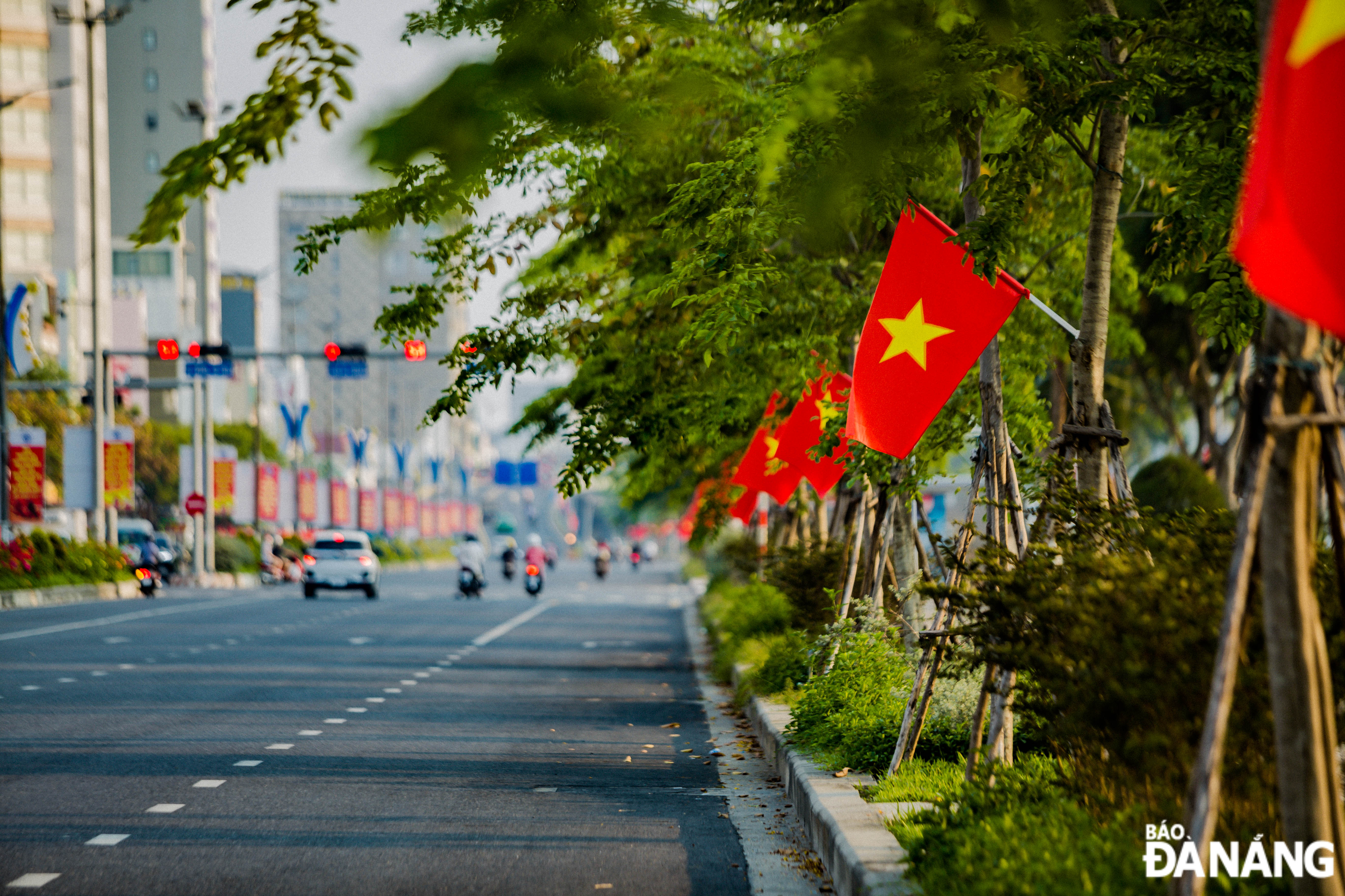 National flags colour streets in the early morning of April 30