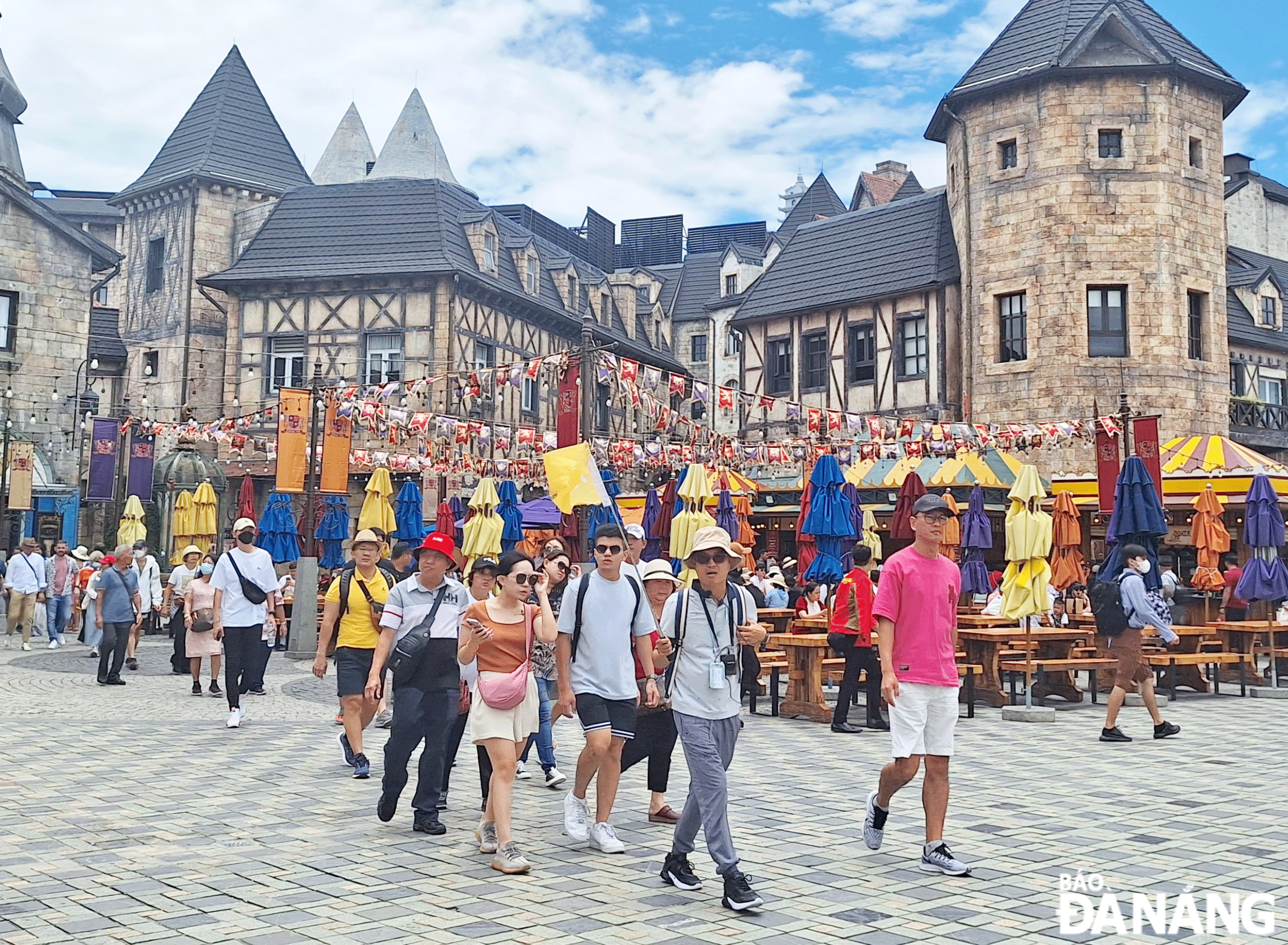 A tour guide and visitors at the Sun World Ba Na Hills tourist area. Photo: THU HA