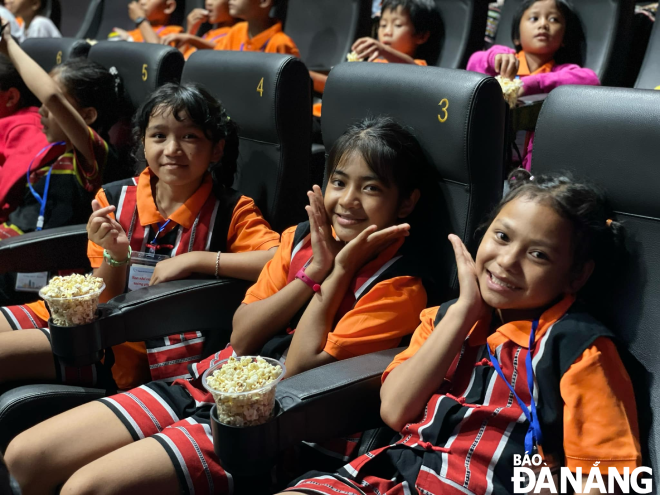 The children are excited to see a movie on a large screen for the first time