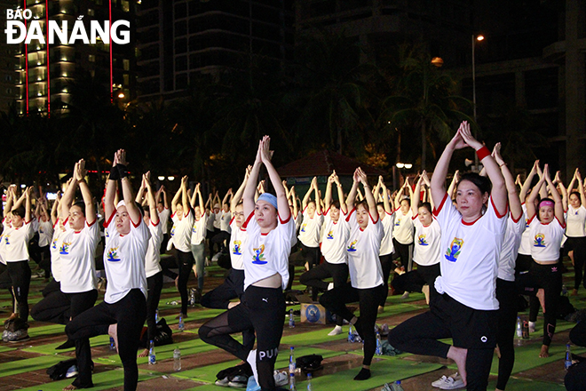 The mass yoga performance attracts more than 1,500 yoga instructors, practitioners, and enthusiasts 