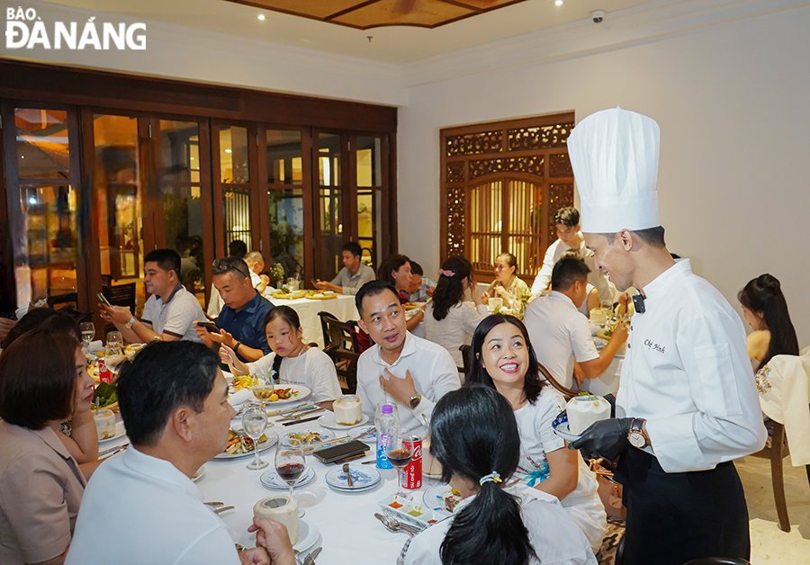 Chefs interacting with diners, and telling stories about dishes they prepared 