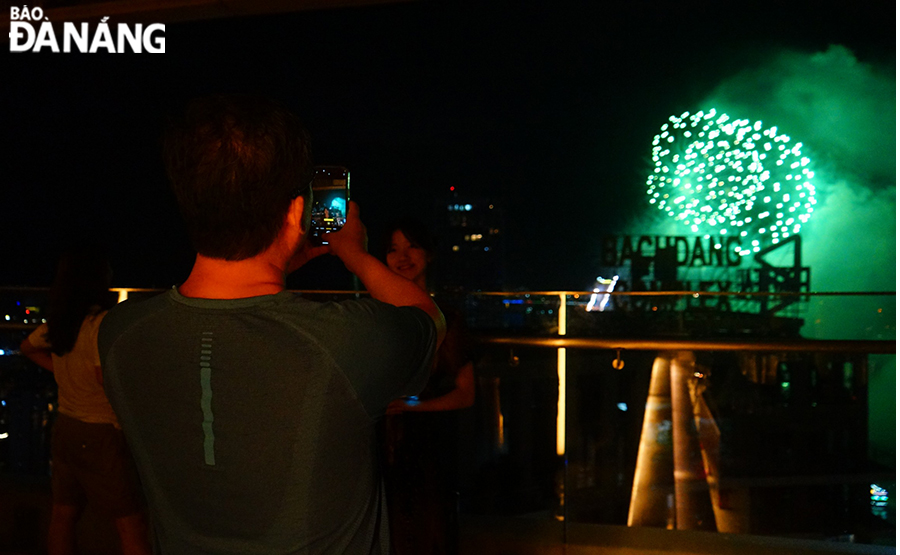 A tourist enjoyed watching fireworks and capturing beautiful moments