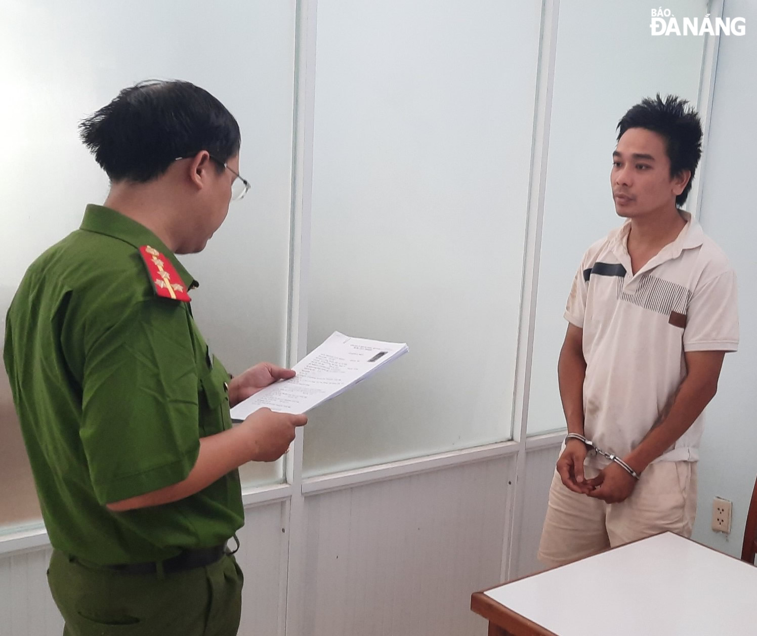Cơ quan Cảnh sát điều tra (Công an thành phố) tống đạt các quyết định đối với Võ Minh (bên phải). Ảnh: L.H
