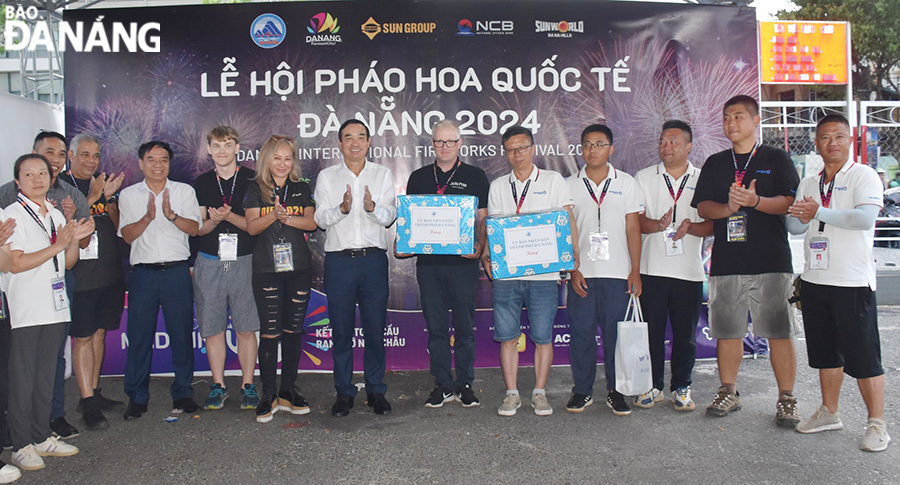 Chairman of the Da Nang People's Committee Le Trung Chinh (7th, right) giving gifts to Chinese and Finnish teams. Photo: THU HA