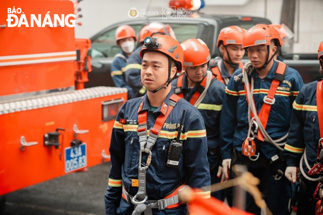 Major Nguyen Huy Linh (left) and his team practice firefighting and rescue operations.