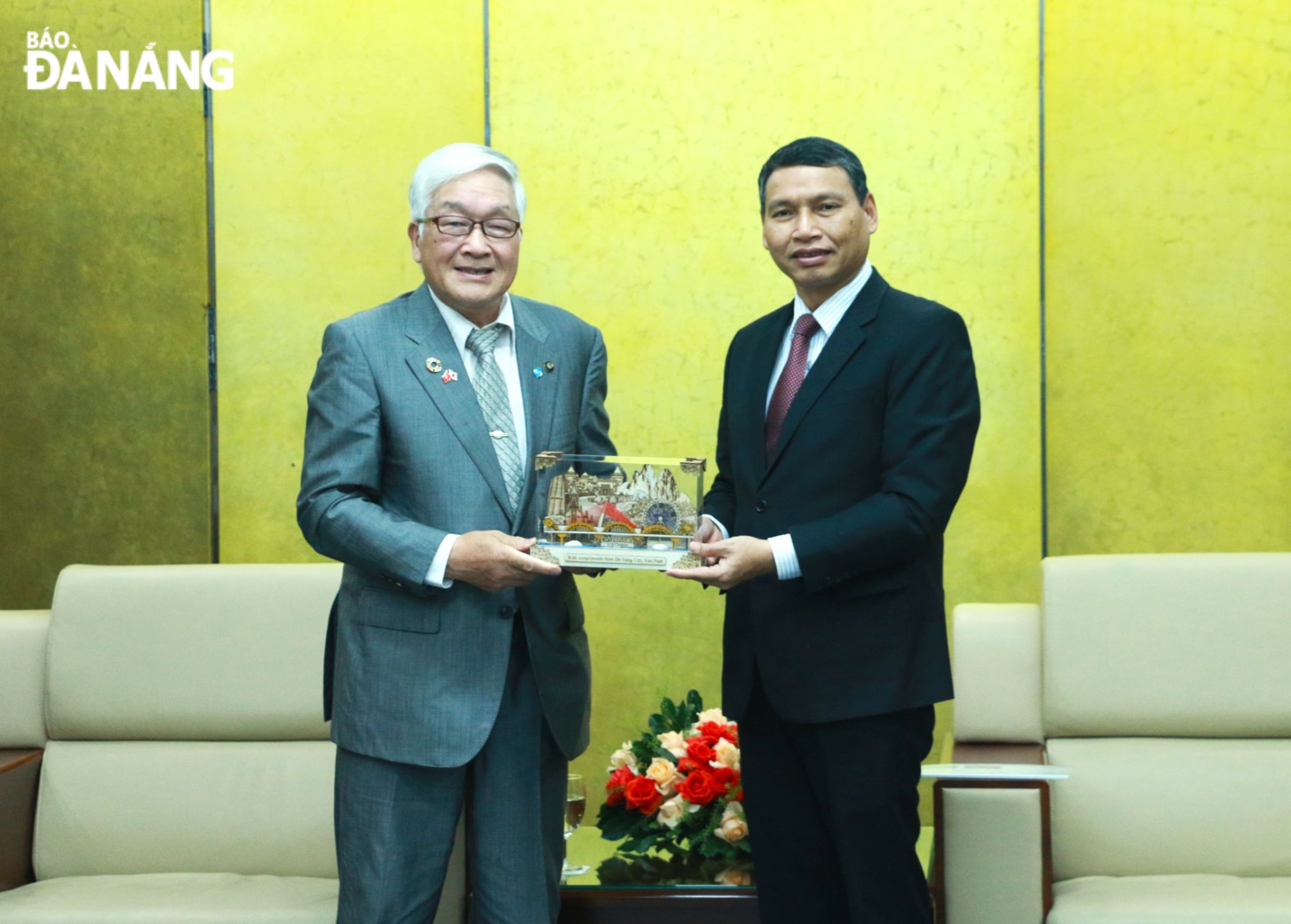 Standing Vice Chairman of the Da Nang People's Committee Ho Ky Minh (right) presenting a souvenir to Mayor of Japan's Niihama City Ishikawa Katsuyuki. Photo: T.P