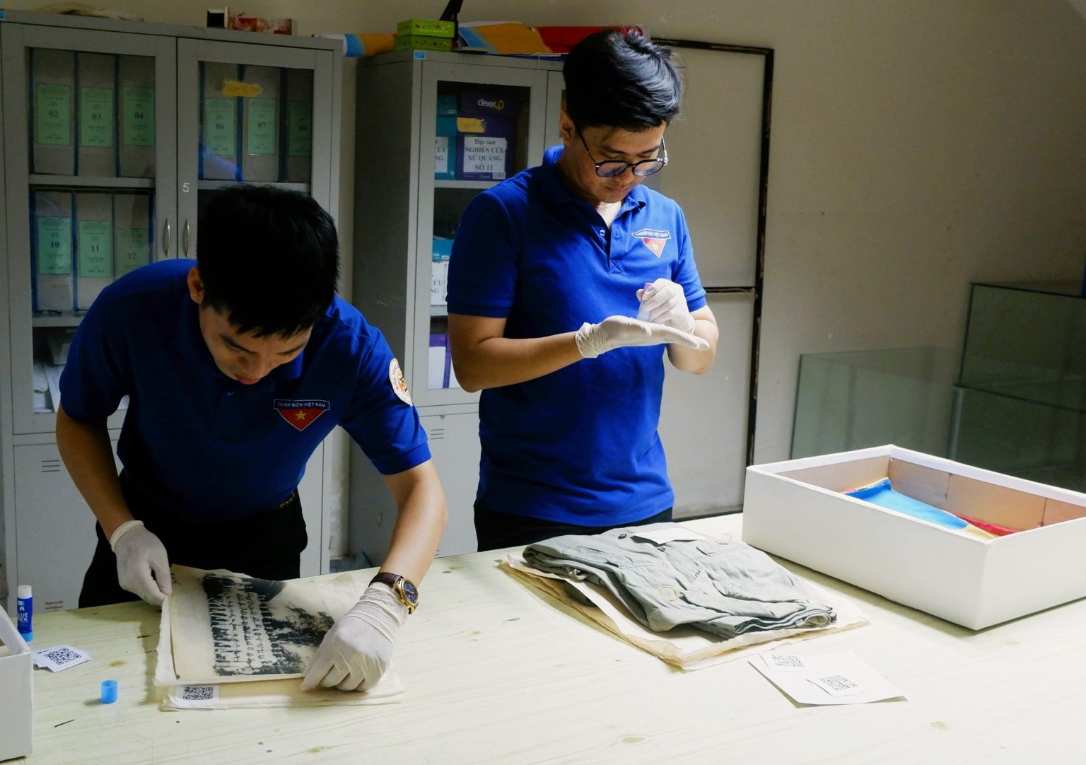 Staff at the Da Nang Museum adding QR codes to artifacts. Photo: D.H.L 