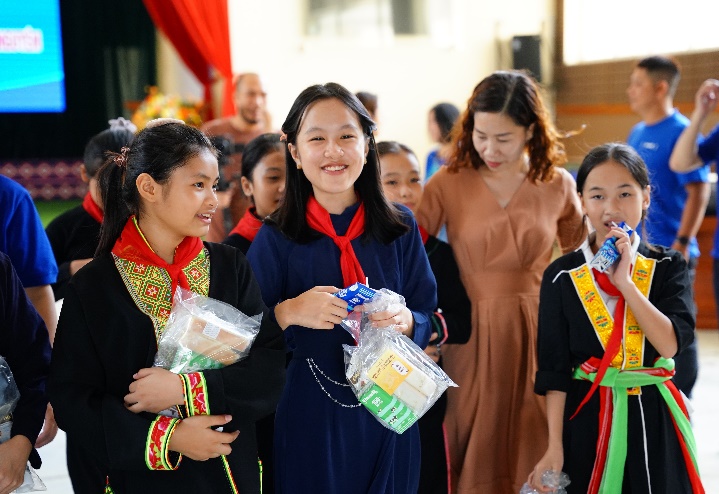 Nhận những phần quà gồm sữa tươi, sữa đặc của Vinamilk và bánh mì, các em đều hớn hở, vui thích vì đã có thể kịp đón trung thu sau những ngày bão lũ. Ảnh: Công ty VNM cung cấp