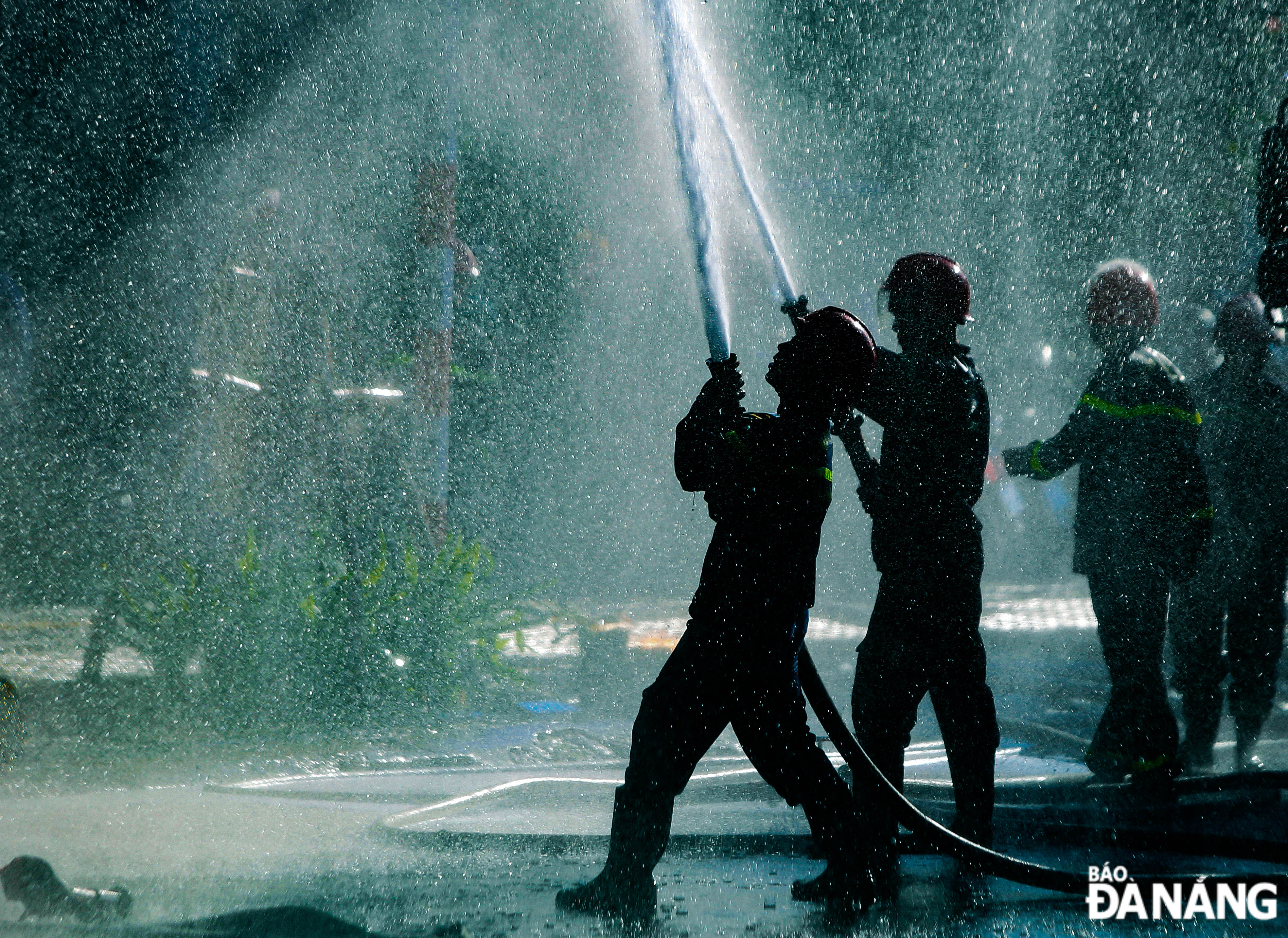 Firefighters spraying water to extinguish the fire