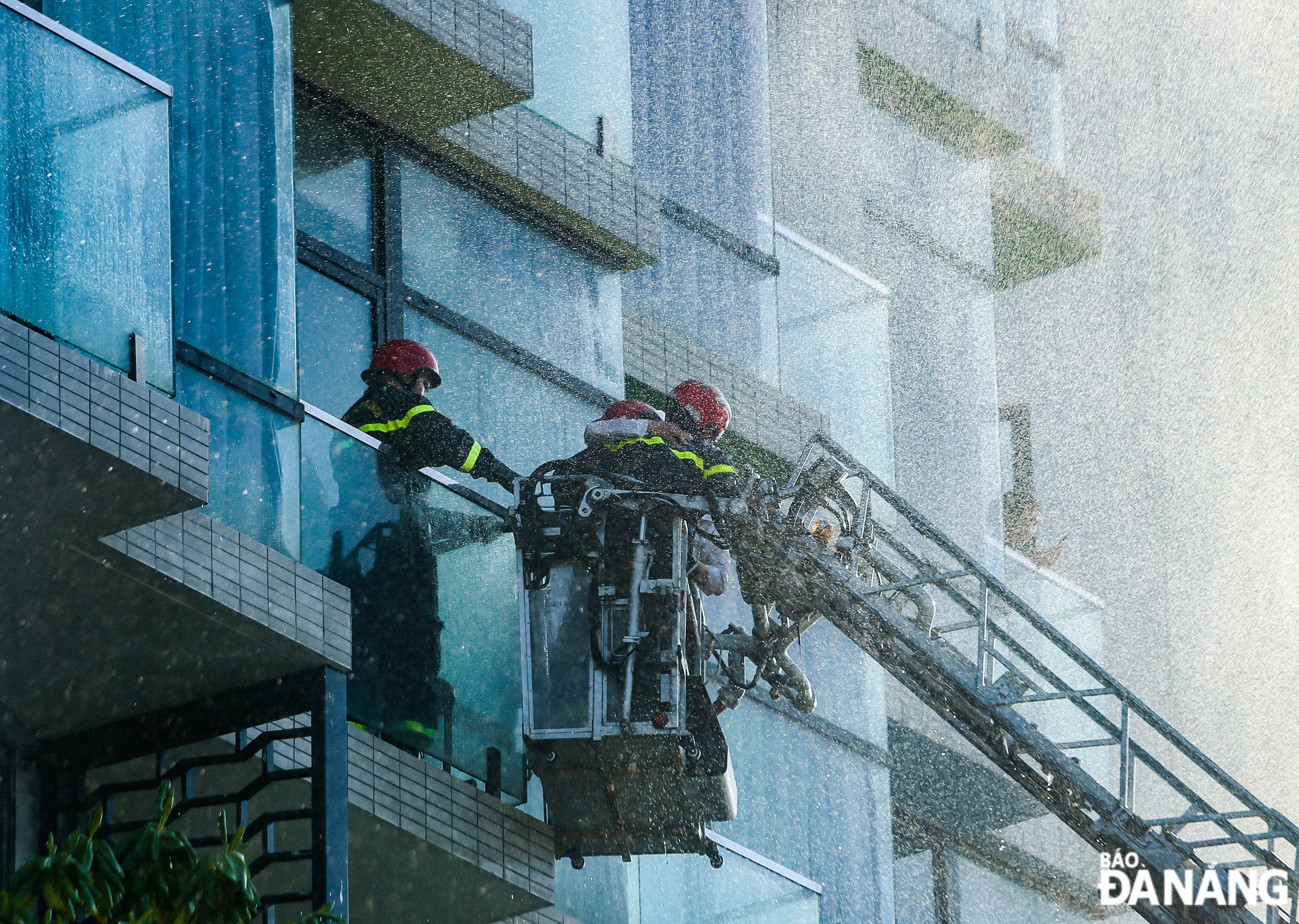 Firefighters safely bringing victims from high places to the ground and handing them over to medical staff