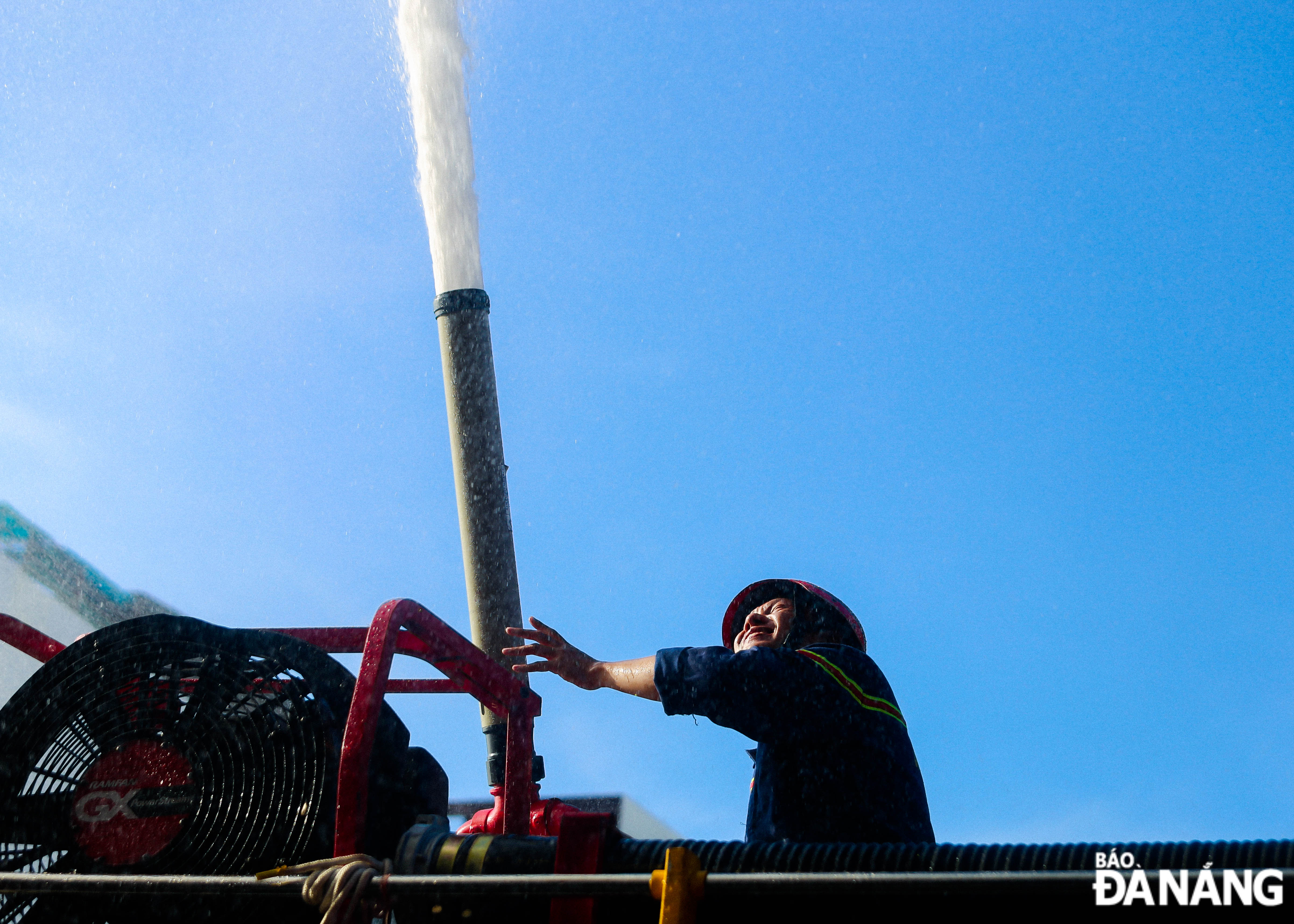 Firefighters in Da Nang participating in a fire drill in the hot weather