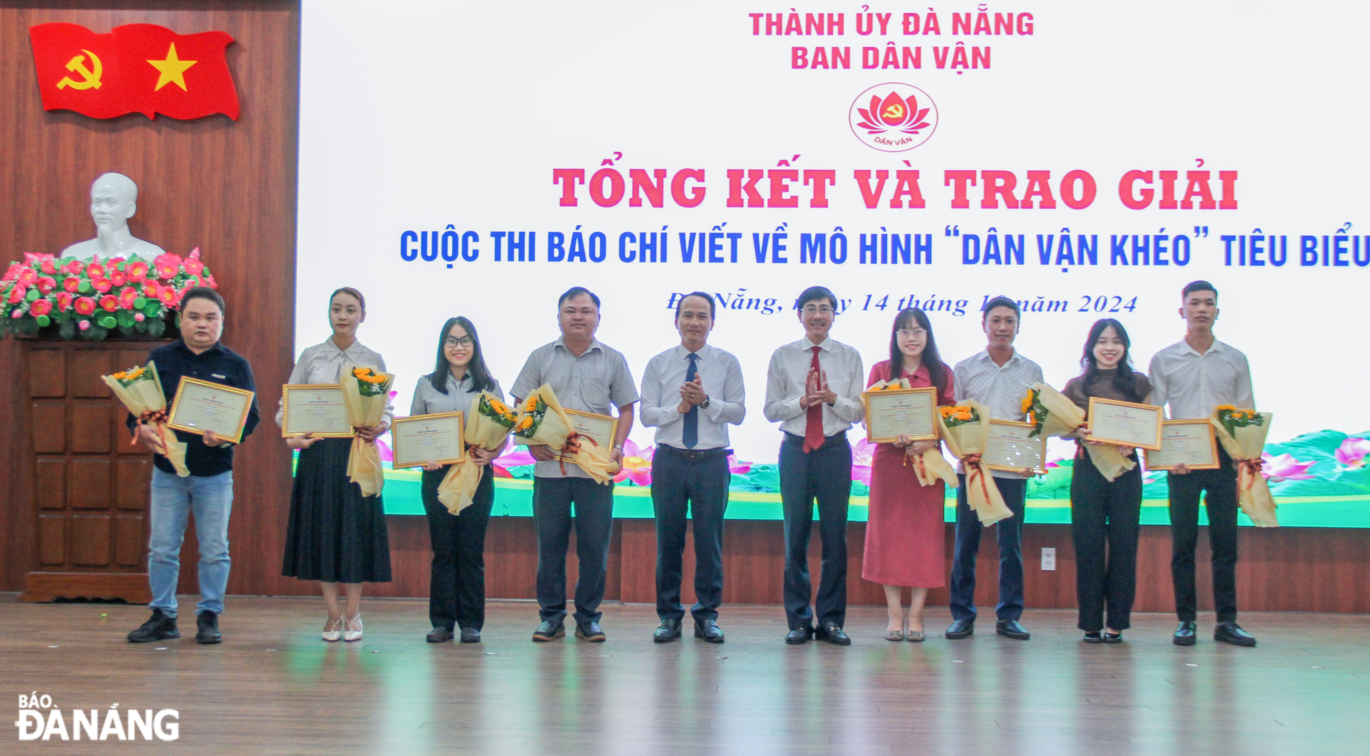 Phó Bí thư Thường trực Thành ủy Nguyễn Đình Vĩnh (thứ 6, bên phải sang), Trưởng ban Dân vận Thành ủy Trần Thắng Lợi (thứ 5, bên phải sang) trao thưởng cho tác giả đoạt giải Nhất tại cuộc thi. Ảnh: H.T