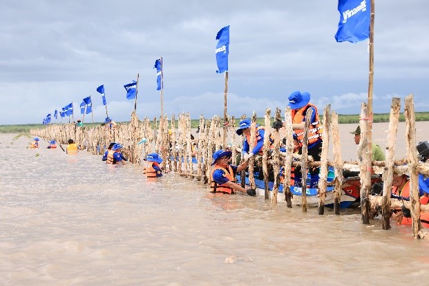 Đoàn nhân viên Vinamilk cùng thực hiện gia cố, sửa chữa hàng rào khoanh nuôi rừng. Ảnh: Công ty VNM cung cấp