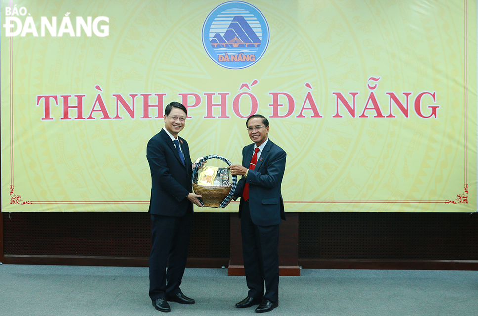 Chairman of Salavan Provincial People's Council Siheang Hom Sombat (right) presenting a souvenir gift to Chairman of the Da Nang People's Council Ngo Xuan Thang. Photo: T.P