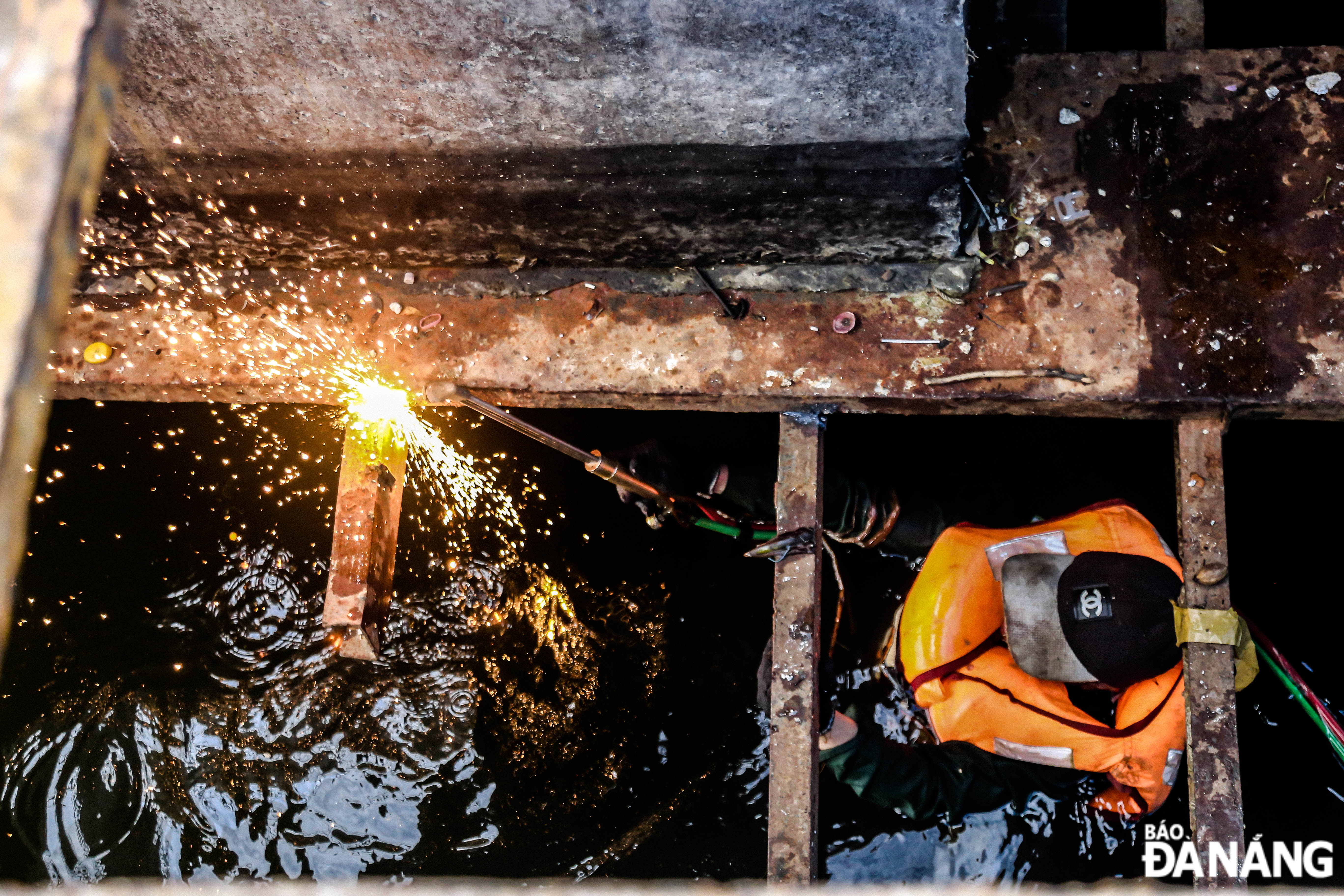 The team of workers waded in the water to work.