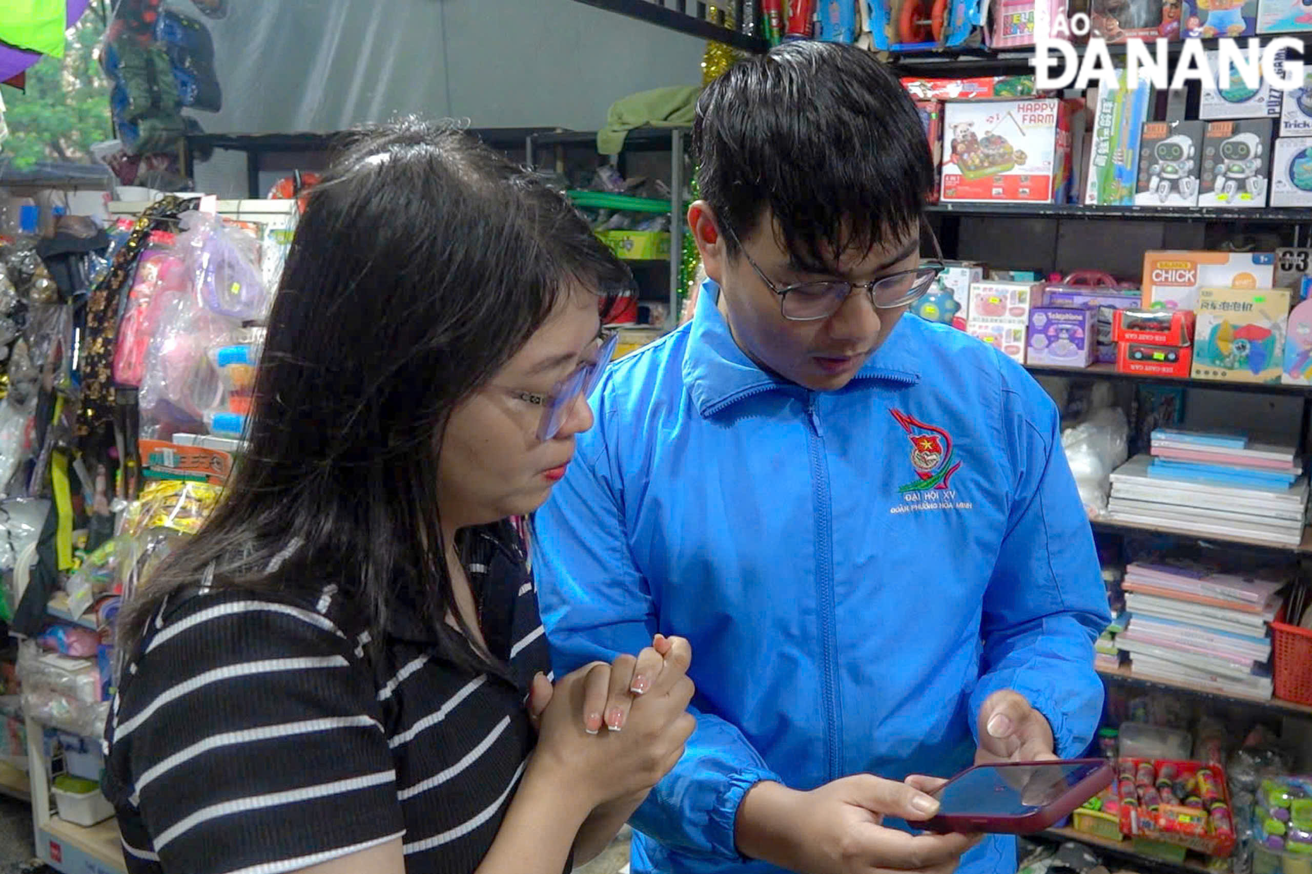 Members of the Youth Union organisation of Hoa Minh Ward guiding people on how to make cashless payments.