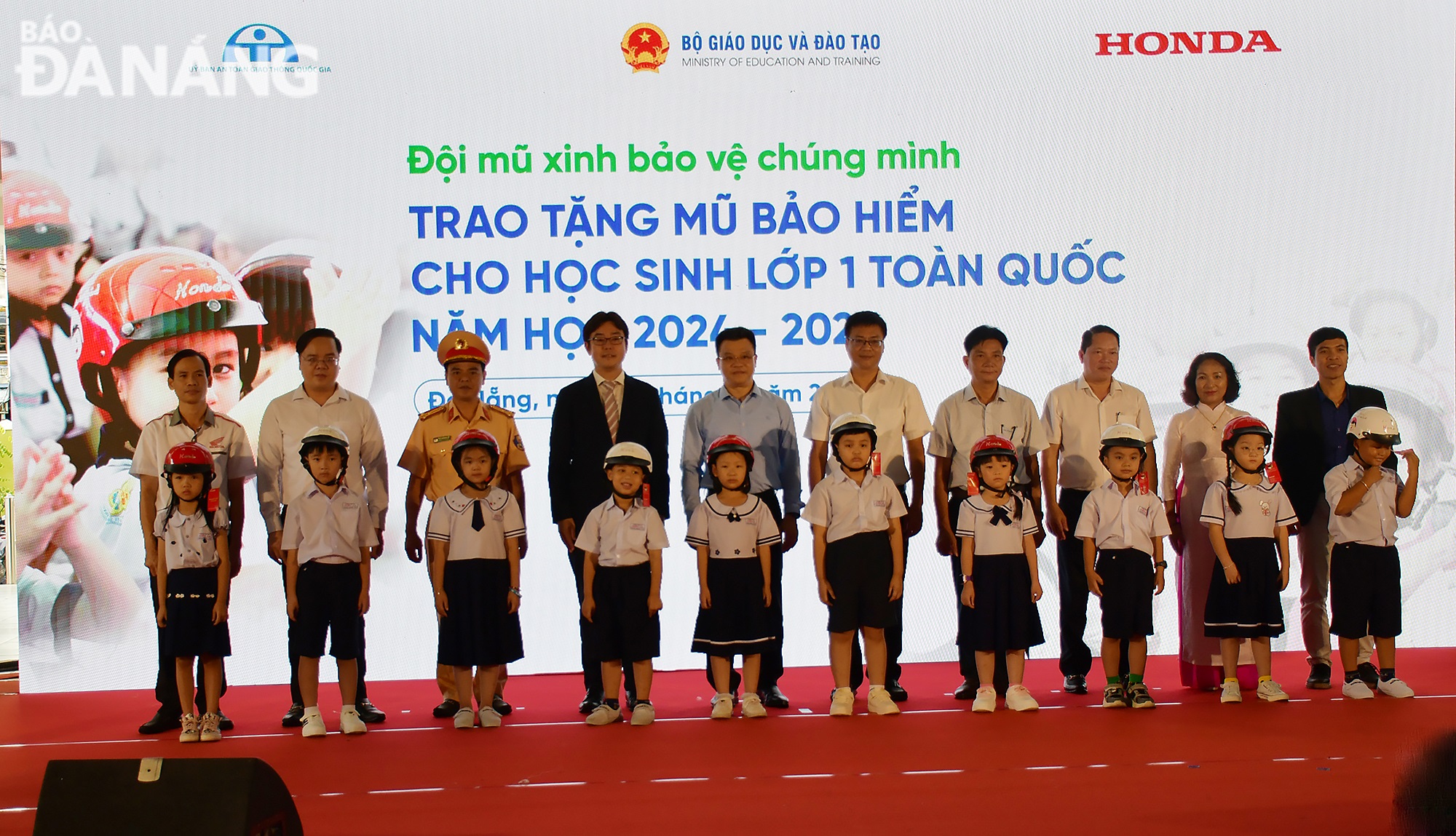 Delegates presenting helmets to first graders of Tieu La Primary School in Da Nang. Photo: THANH LAN