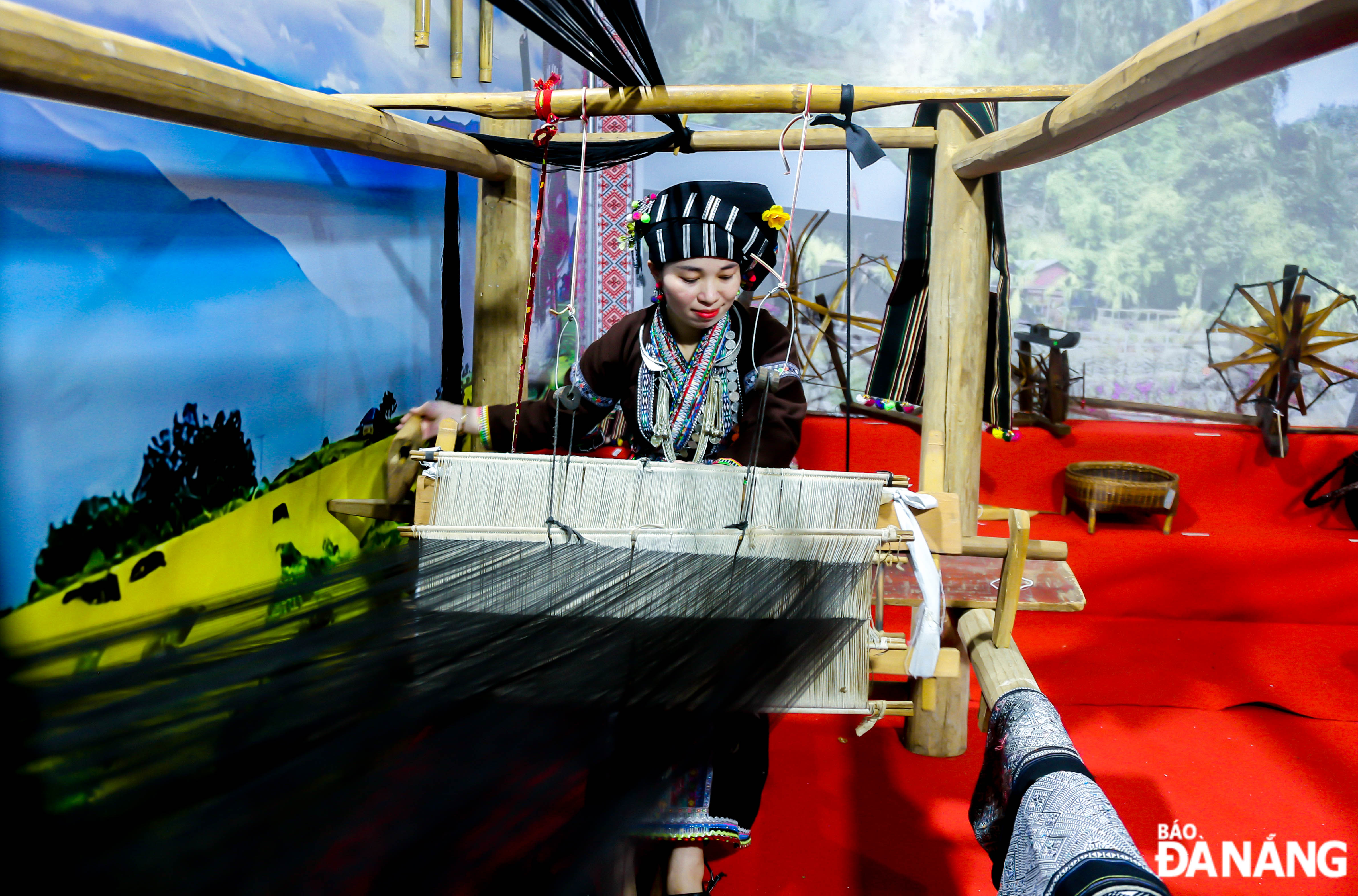 A woman demonstrating traditional weaving skills of Lu ethnic minority people