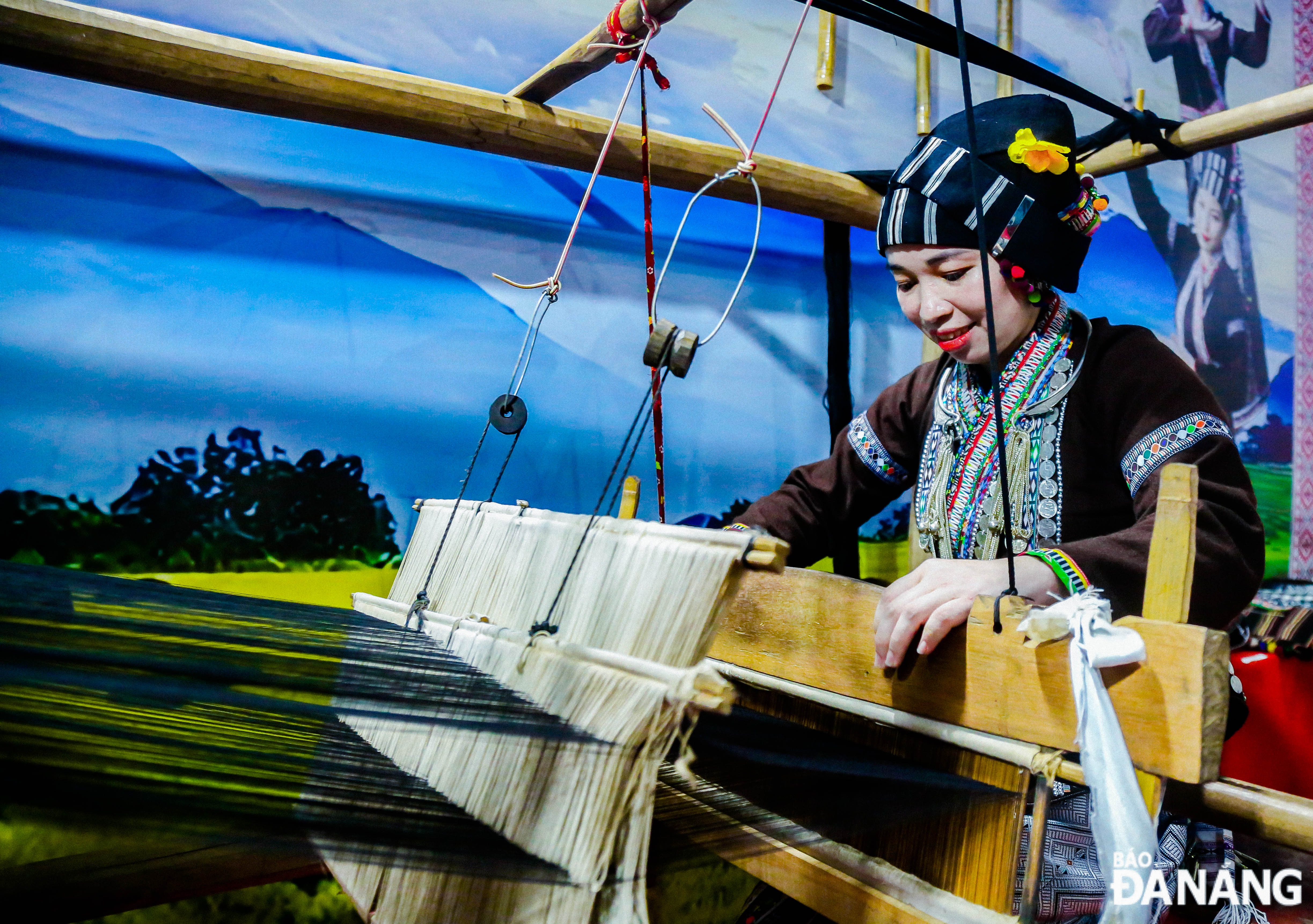 A woman demonstrating traditional weaving skills of Lu ethnic minority people