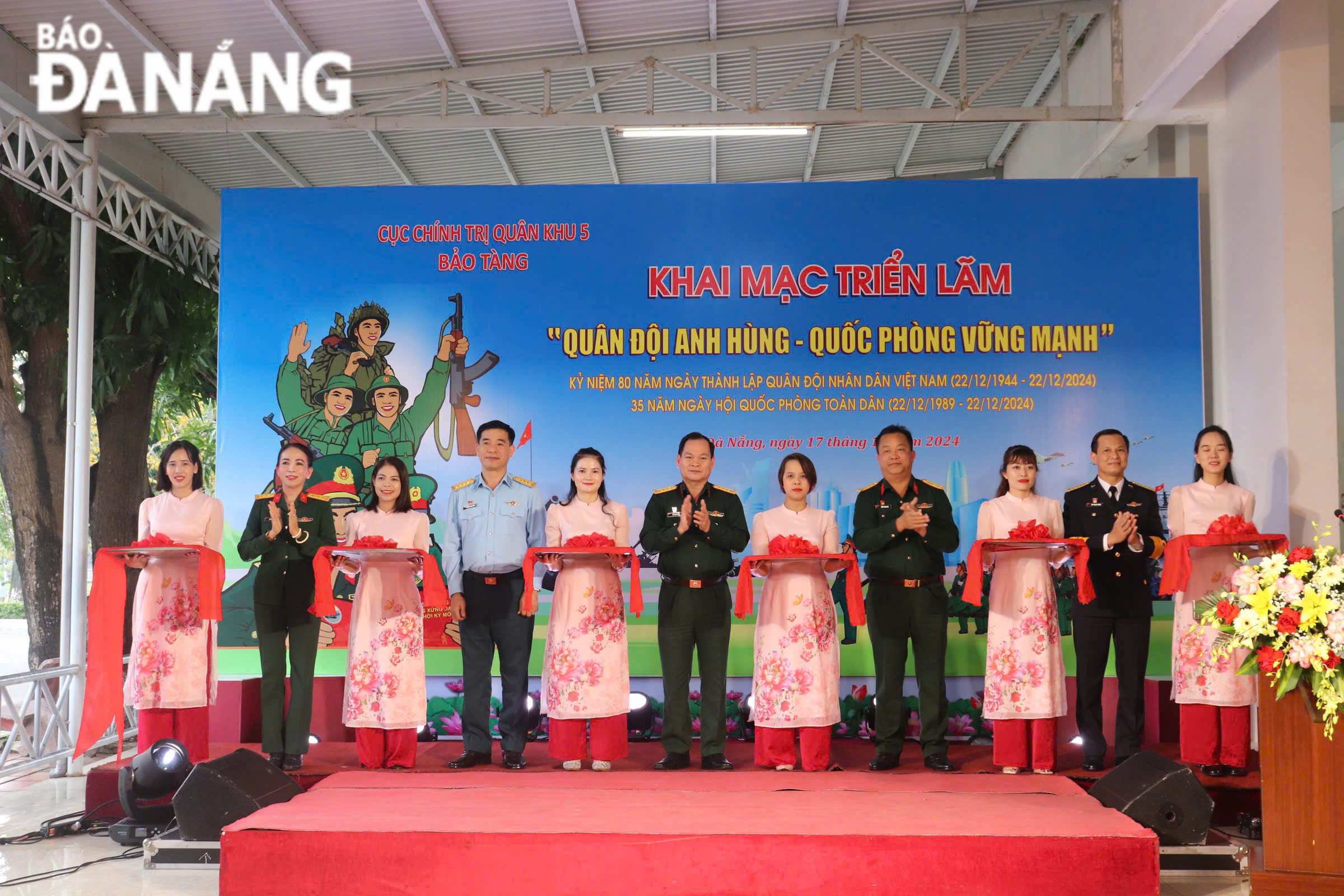 Delegates cutting the ribbon to open the exhibition. PHOTO: KHANH NGAN