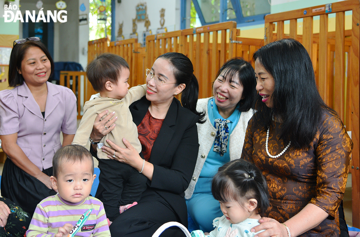 Vice Chairwoman of the Da Nang People's Committee Nguyen Thi Anh Thi (middle) visiting children studying at the OneSky Da Nang Preschool Care and Education Centre. Photo: XUAN DUNG