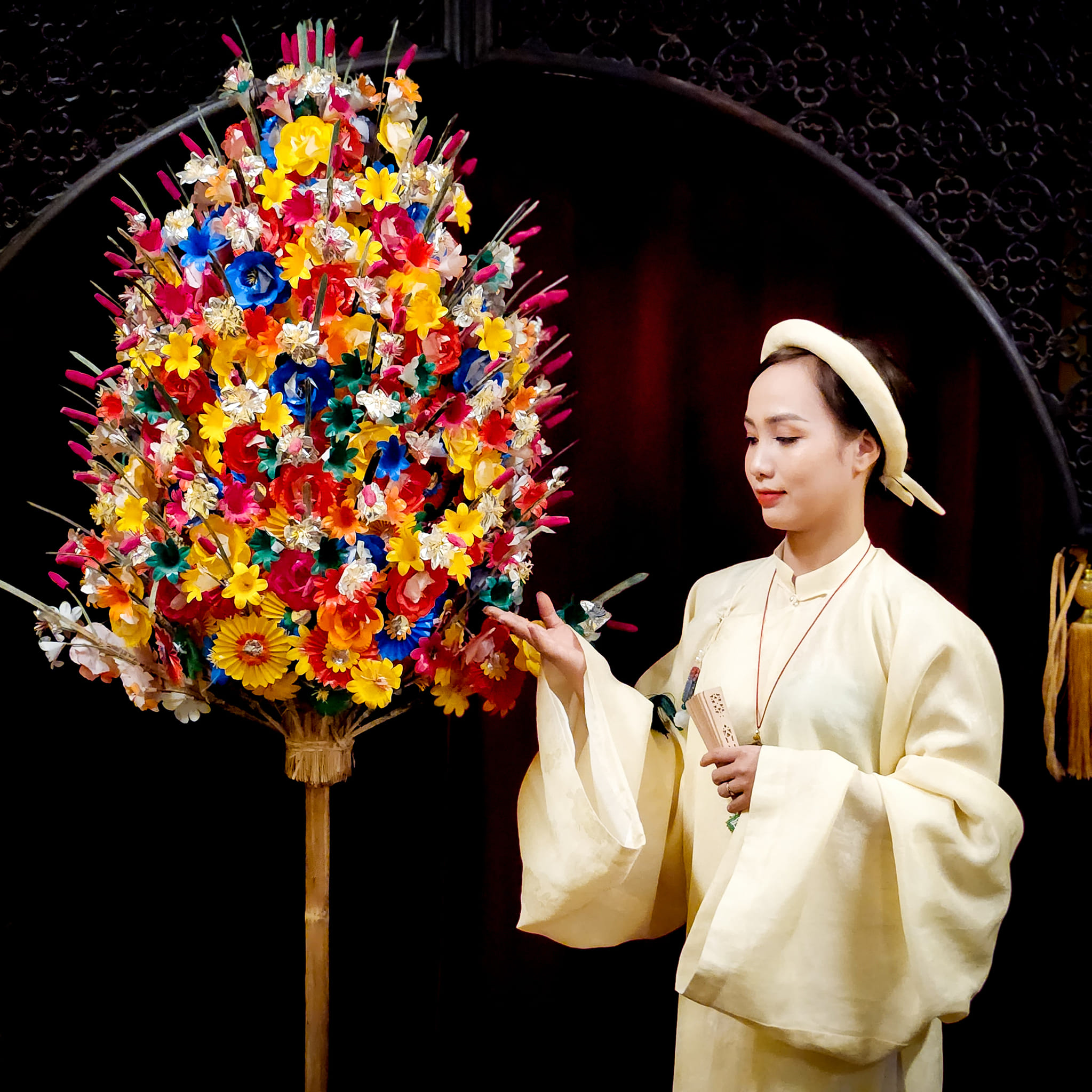 Visitors admire and pose alongside the exquisite paper flowers.