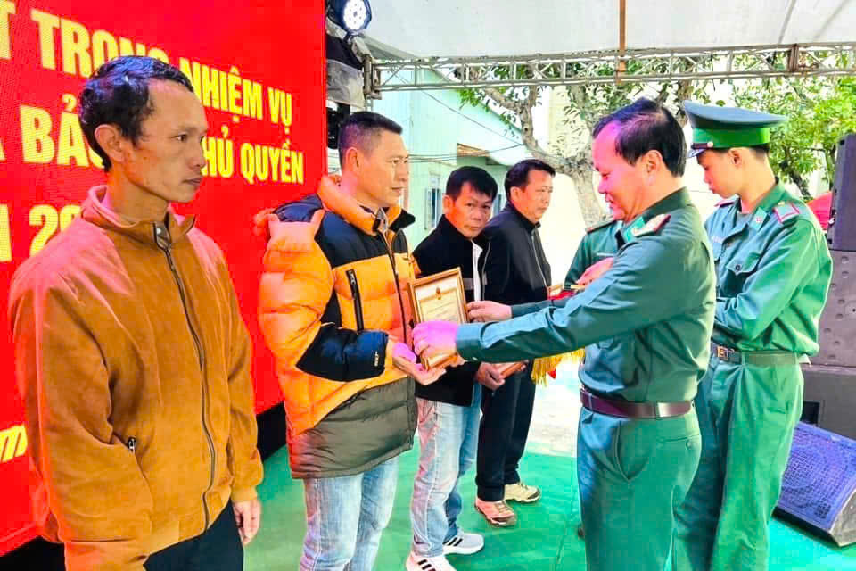 Đại tá Đỗ Văn Đông khen thưởng cho các ngư dân có đóng góp trong công tác bảo vệ chủ quyền biển, đảo. Ảnh: KIM NGÂN